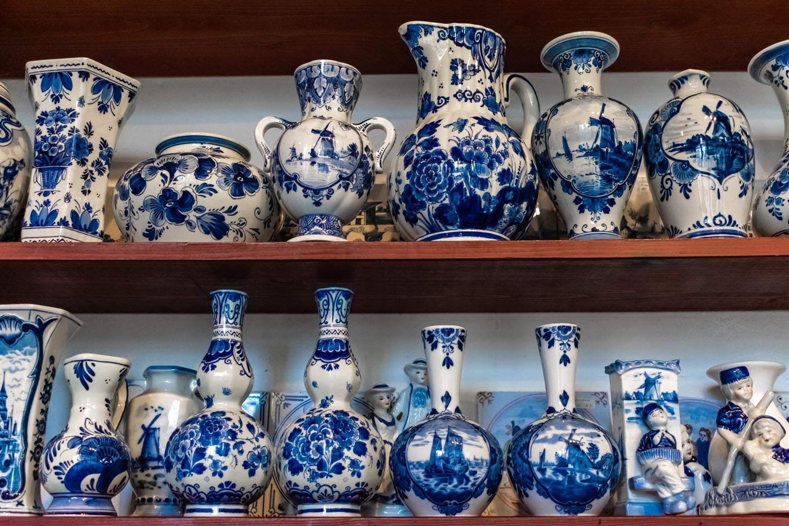 Traditional blue and white Delftware vases displayed on wooden shelves