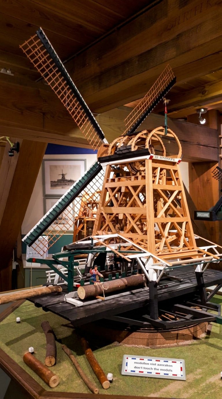 Detailed wooden model of a traditional Dutch sawmill inside a windmill museum
