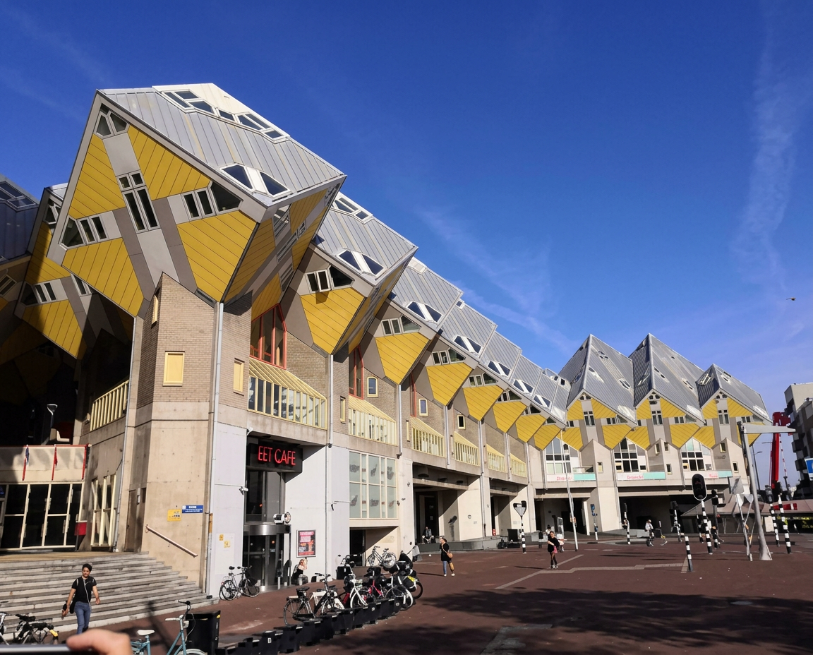 Rotterdam's yellow Cube Houses lining the pedestrian plaza under a blue sky